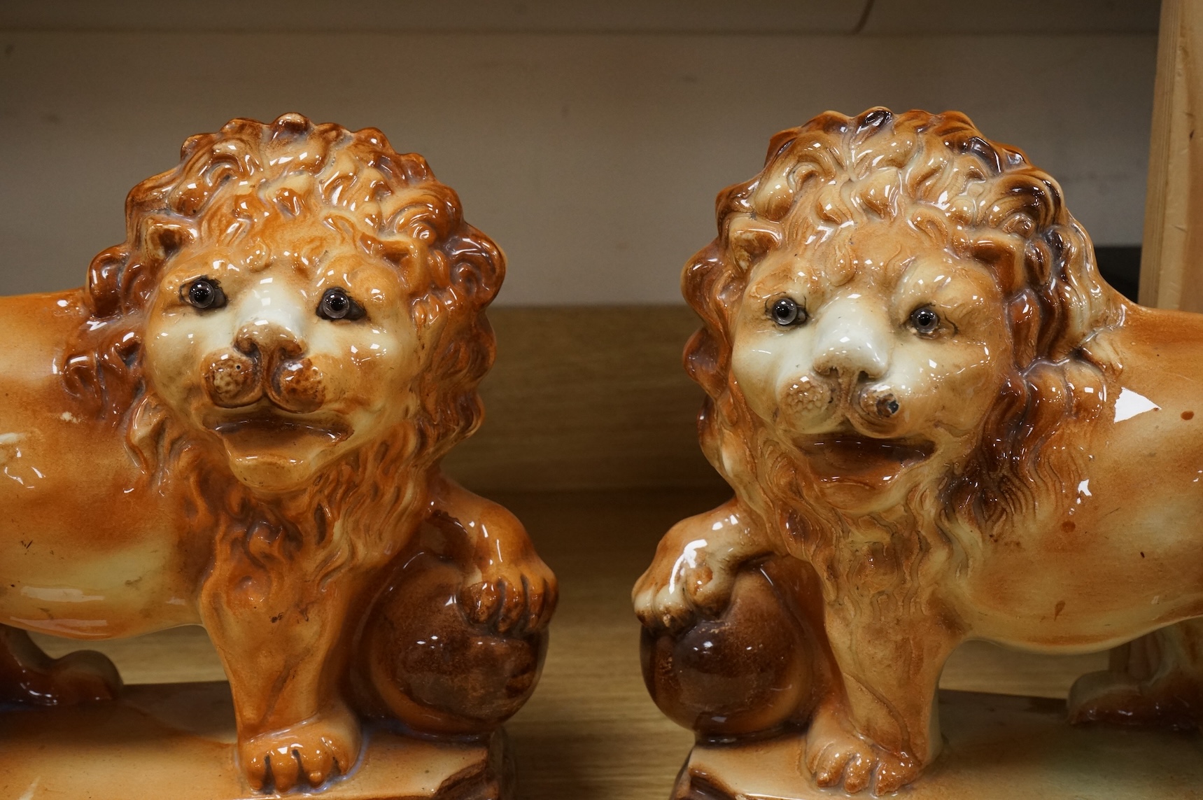 A pair of Staffordshire pottery lions, c.1900, 34cm